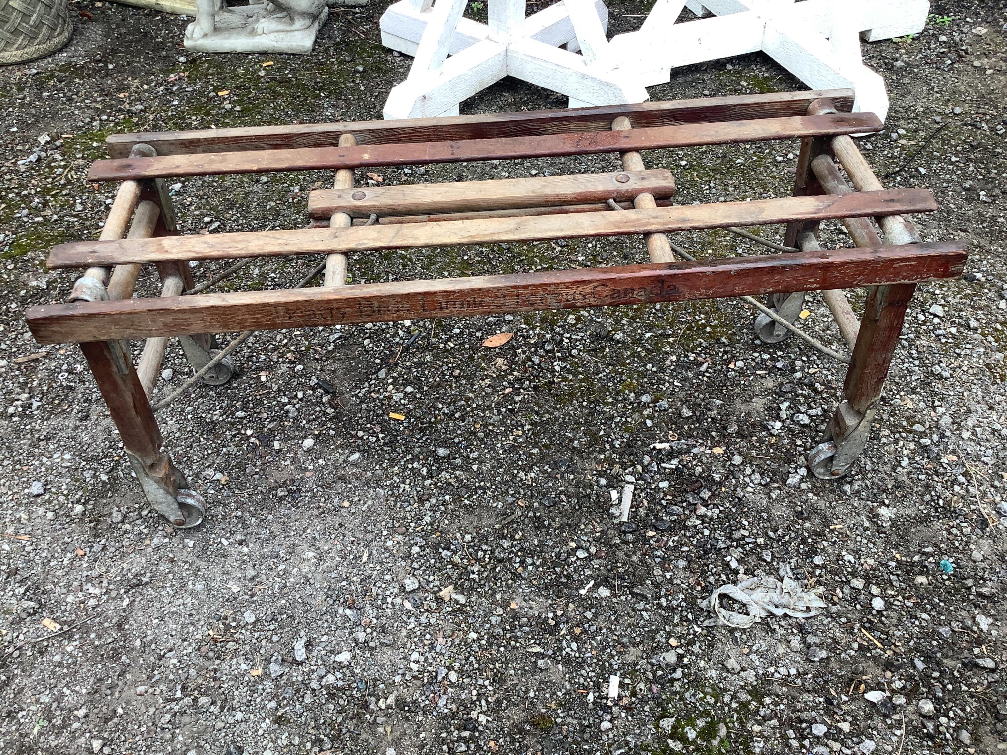A vintage Beatty Bros. Ltd. folding wheeled stand and galvanised container, six other galvanised and enamel containers and sundries. Condition - fair